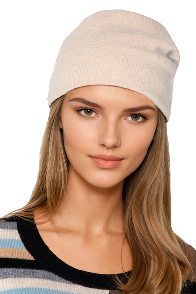 Woman wearing a subtle luxury cashmere hat beanie  in oatmeal tan