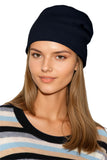 Woman wearing a 100% Cashmere hat black beanie and striped sweater cashmere sweater