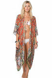 Model wearing a long Subtle Luxury modal kimono coverup in a vibrant orange and green masala print with raw edges. Masala Luxury Red Print Kimono Coverup