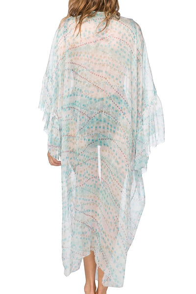 Subtle Luxury silk kimono coverup featuring a geo squared print and flowing bell sleeves worn over a black bodysuit. 2