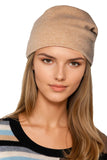 Woman wearing a beige 100% cashmere hat  beannie - subtle luxury cashmere accessories