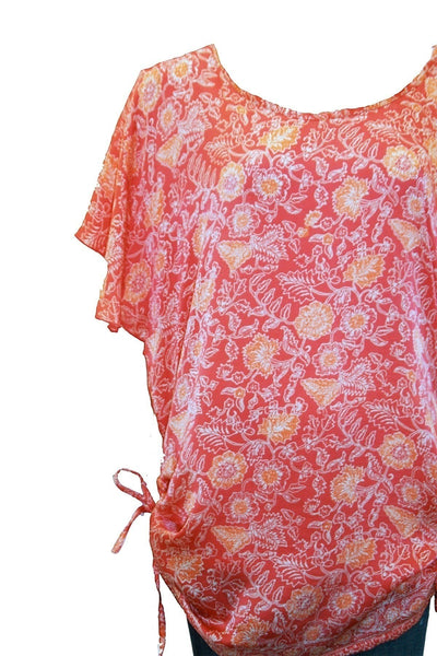 Subtle Luxury printed silk tunic dress in coral with floral pattern, crew neck, short sleeves, and side drawstrings.