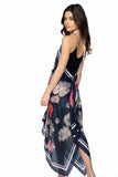 Subtle Luxury navy floral print halter neck dress with handkerchief hem worn by a model against a white background.
