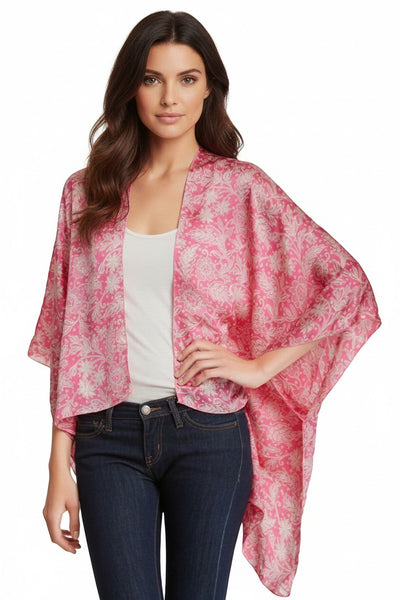 Subtle Luxury pink silk kimono jacket with white floral print and hi-low hemline worn by a model