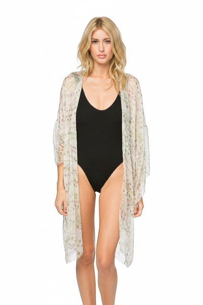Subtle Luxury silk kimono coverup with bell sleeves and geo squared print worn by a model over a black swimsuit