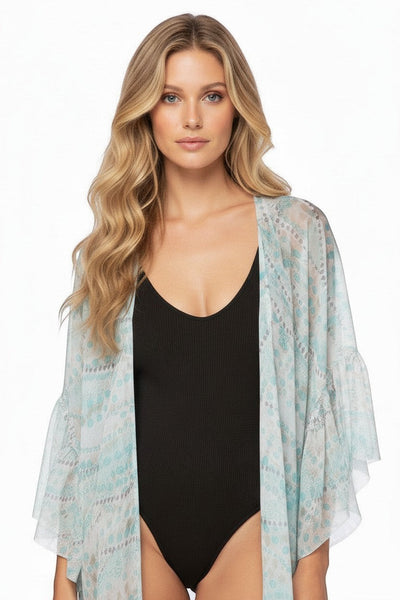 Subtle Luxury silk kimono coverup featuring a geo squared print and flowing bell sleeves worn over a black bodysuit.